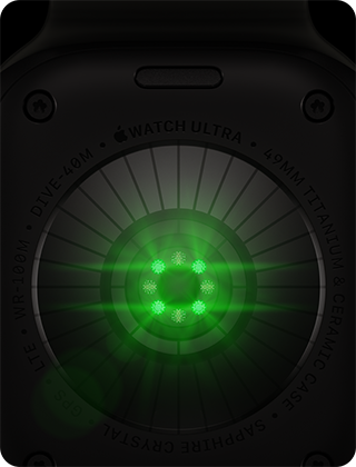 Back of Apple Watch Ultra 4, titanium case, black color, multiple round sensors with glowing green LED lights